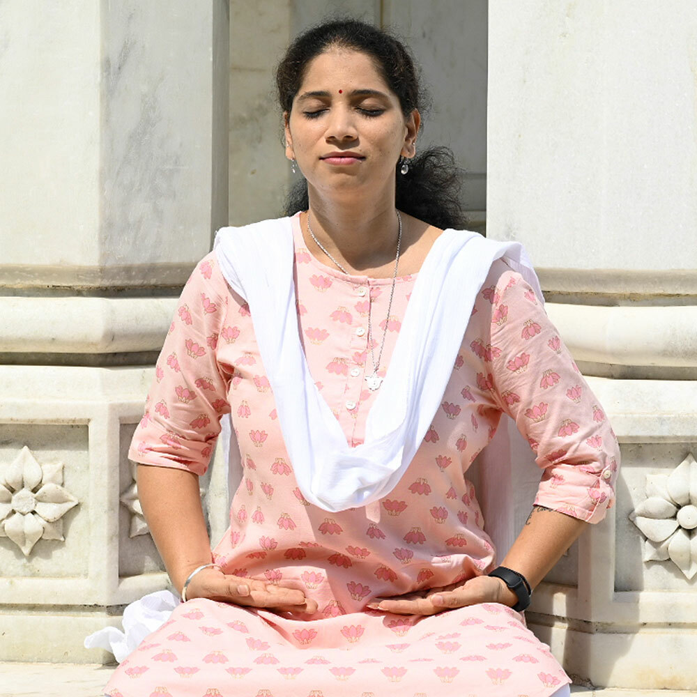 Devotee meditating in front of Indian temple SQ